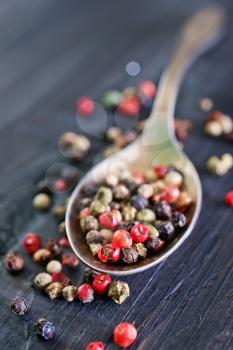 pepper mix in metal spoon and on a table