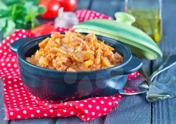 braised cabbage in bowl and on a table