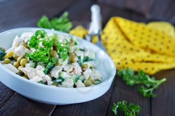 salad with boiled chicken and cucumber in the bowl