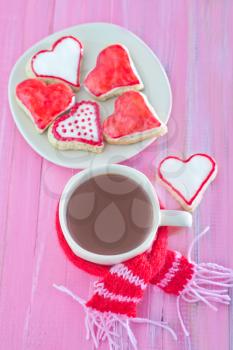 sweet cookies and cocoa drink on a table