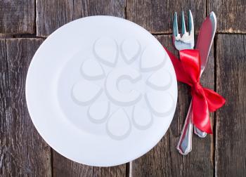 fork and knife on plate and on a table