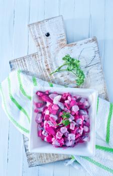 beet salad in bowl and on a table