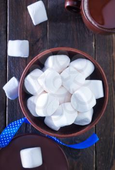 white marshmallows in the bowl and on a table