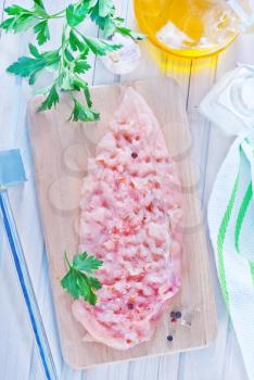 raw chicken on board and on a table