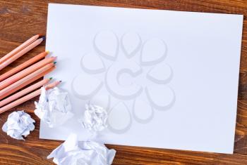 paper on wooden background, white paper on a table