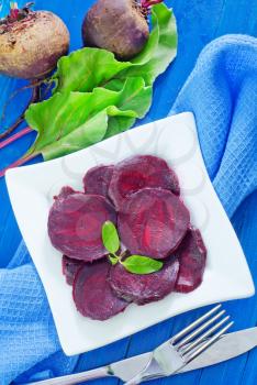 boiled beet on plate and on a table