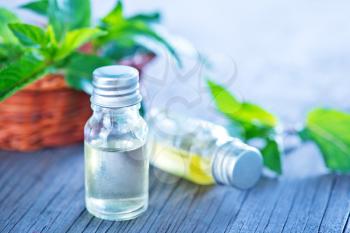 mint oil in bottle and on a table