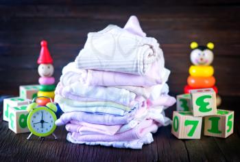 baby clothes  and toys on a table