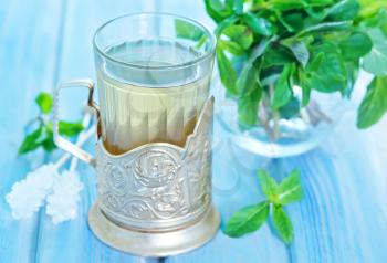 mint tea in glass and on a table