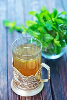 fresh mint tea in glass and on a table