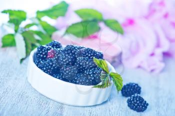 blackberry in bowl and on a table