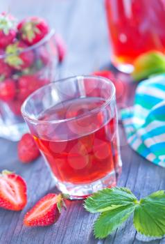 strawberry drink in cup and on a table