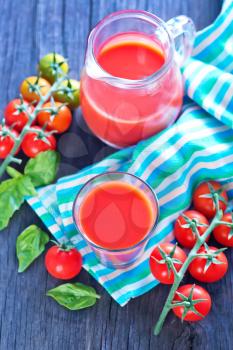 tomato juice in the glass and on a table