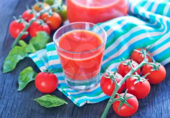 tomato juice in the glass and on a table