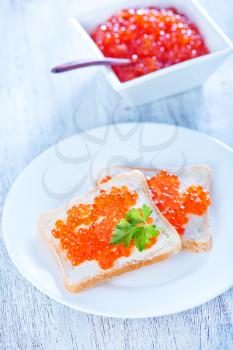 salmon caviar and bread on a table