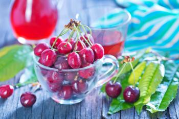 fresh cherry and fresh juice on the wooden table