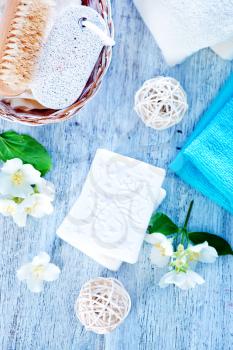 white aroma soap and flowers on a table