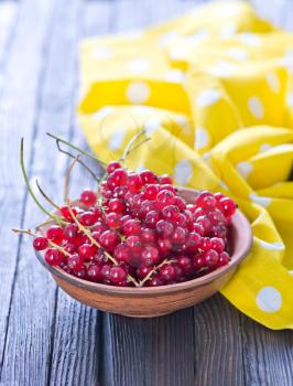 red currant in bowl and on a table