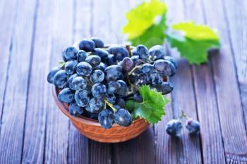 grape in bowl and on a table