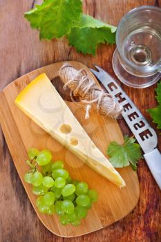 cheese and grape on the wooden table