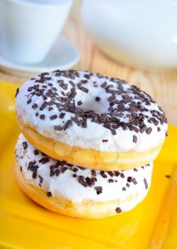 Delicious doughnuts on the yellow plate, donuts with chocolate