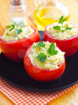 Baked tomato with boiled eggs and cheese