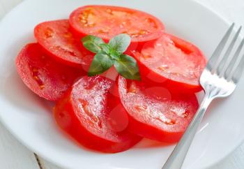 salad with fresh tomato, olive oil and green basil