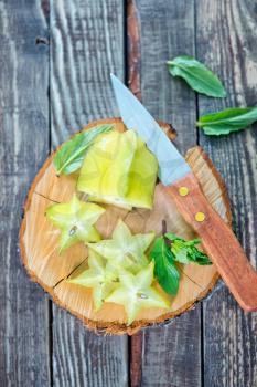 carambola on wooden board and on a table