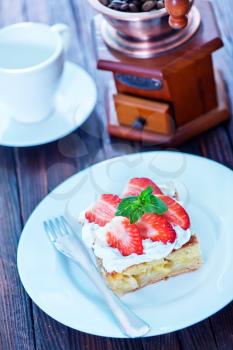 pie with cream and fresh strawberry on plate