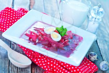 beet soup in bowl and on a table