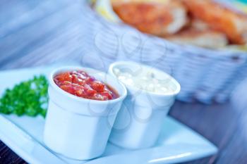 fast food on the wooden table, chicken with sauce