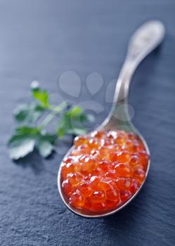 red salmon caviar in the metal spoon