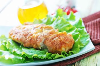 chicken breast with salad on the plate