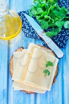 cheese and fresh parsley on a table