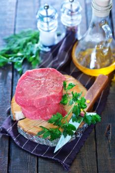 raw meat and parsley on the table