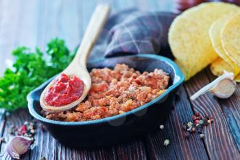 a bowl of fried ground meat with tomatoes ready for tacos