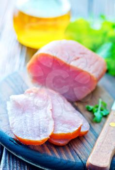 smoked meat and knife on the wooden board