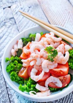 salad with shrimps in bowls and on a table