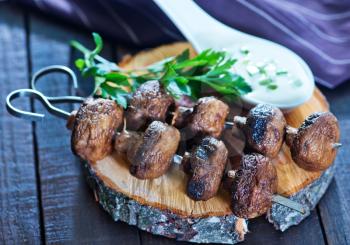 fried mushrooms on the wooden board and on a table