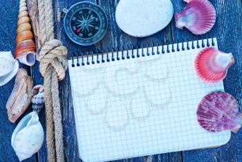 background, sea shells and compass on a table