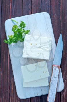 feta cheese on board and on a table