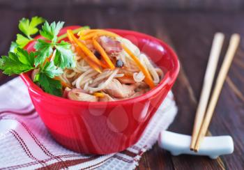 rice noodles with meat and vegetables in bowl