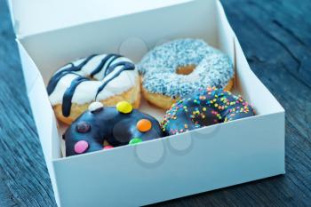 donuts in white box and on a table