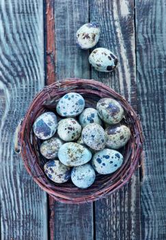 quail eggs in the nest and on a table
