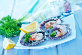 scallop with caviar and lemon juice on a table