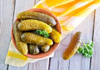 pickled cucumbers in bowl and on a table