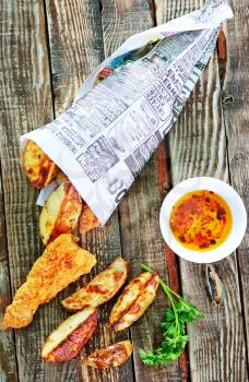 fish and chips on the wooden table