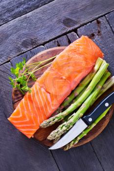 raw salmon with lemon and salt on a table