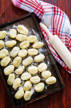 raw potato gnocchi on the wooden table 