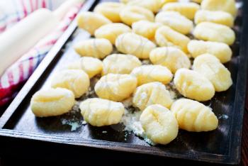 raw potato gnocchi on the wooden table 
